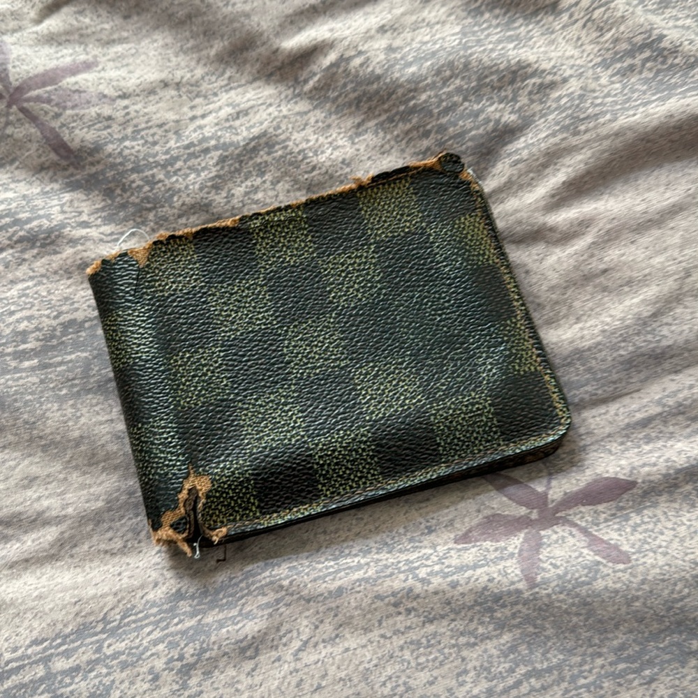 Vintage Louis Vuitton wallet. Wallet is very old, cracking and a bit rotted.